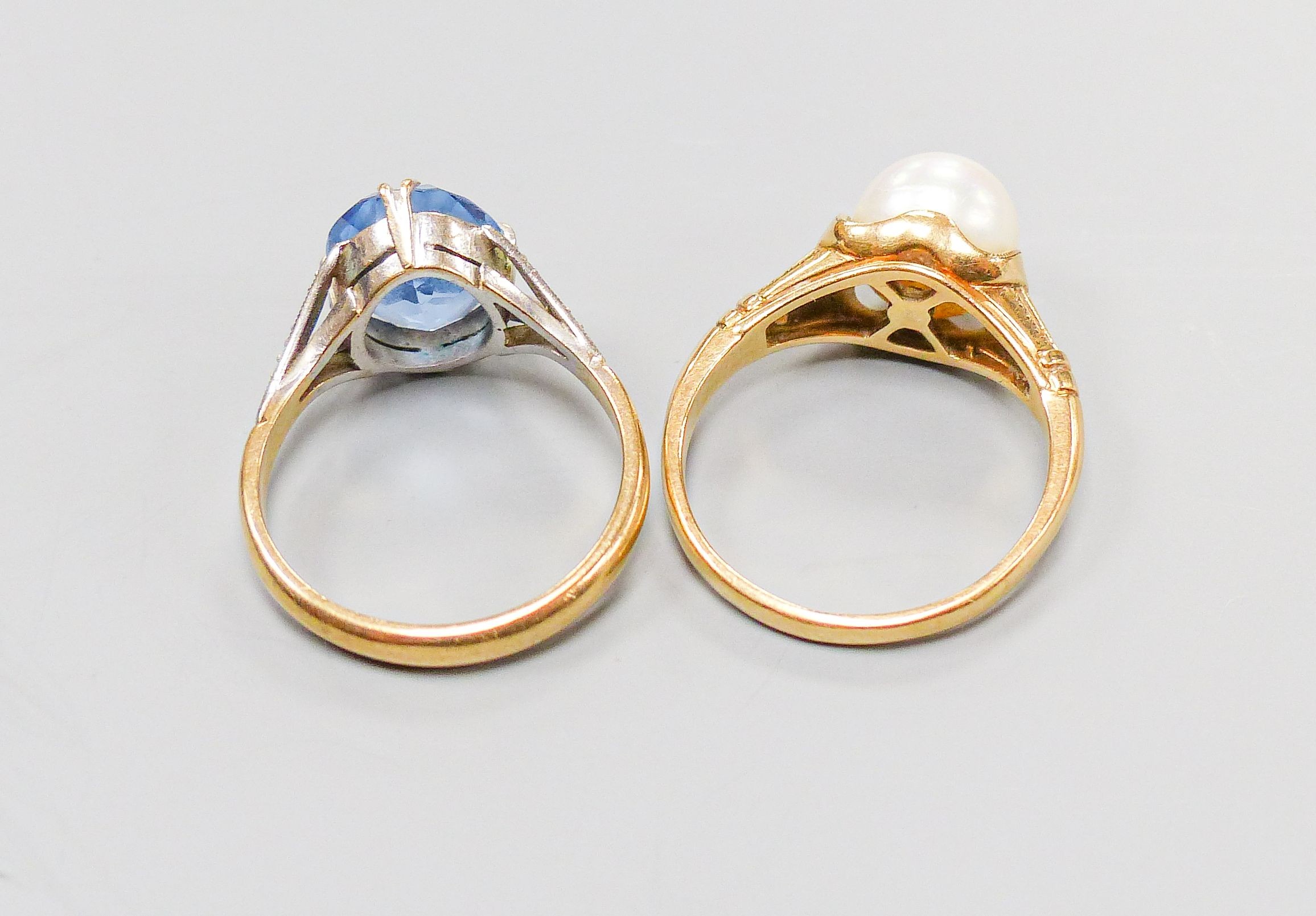 A 14K ring set with a cultured pearl in a fancy mount, size O, gross 4 grams and a 9ct gold dress ring set with an oval blue stone, 3.4 grams.